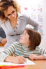 Image showing Teacher looking at student