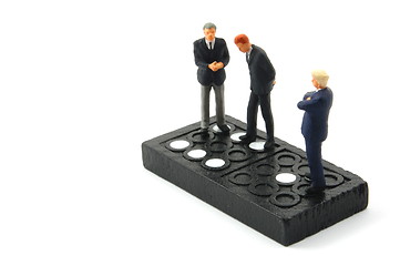 Image showing business man on domino isolated