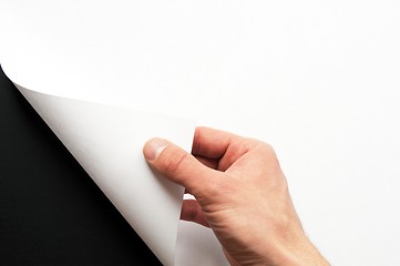 Image showing hand turning paper