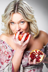 Image showing blonde woman with pomegranate