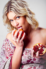 Image showing blonde woman with pomegranate