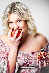 Image showing blonde woman with pomegranate