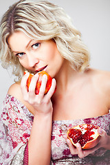 Image showing blonde woman with pomegranate