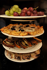 Image showing Grapes and various cakes