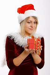 Image showing girl in santa hat with a gift