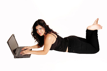 Image showing Lying girl with laptop.