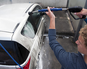 Image showing Washing a car