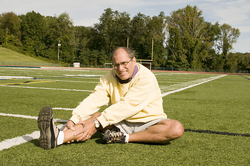 Image showing middle age senior man exercising on sports field