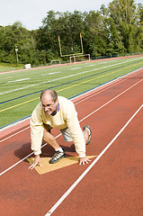Image showing middle age senior man exercising running on sports field and run