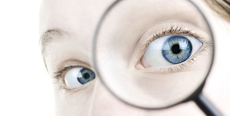 Image showing Eye looking thorough magnifying glass