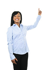 Image showing Smiling young woman pointing up