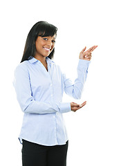 Image showing Smiling young woman pointing