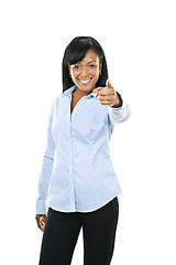 Image showing Smiling young woman pointing finger