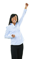 Image showing Excited happy young woman with arm raised