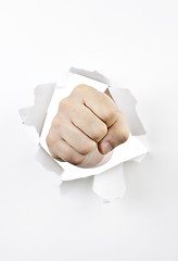 Image showing Fist punching through hole in paper
