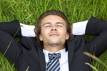 Image showing Well-dressed young businessman is resting 