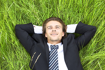 Image showing Well-dressed young businessman is resting