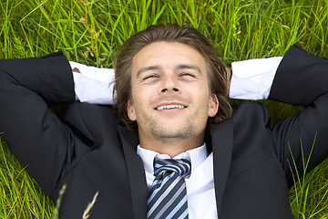 Image showing Well-dressed young businessman is resting