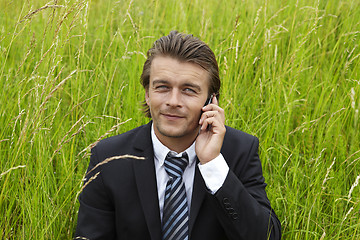 Image showing young businessmann is on the phone