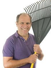 Image showing middle age senior man holding garden leaf rake tool