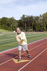 Image showing middle age senior man exercising running on sports field and run