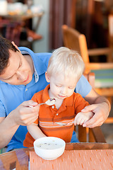 Image showing father and son having breakfast