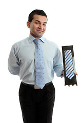 Image showing Smiling salesman proudly with a product merchandise