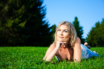 Image showing attractive woman lying on green fresh