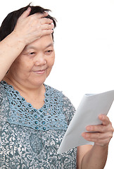 Image showing Closeup portrait of smiling senior woman reading a book 