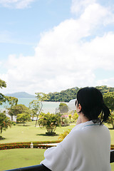 Image showing Beautiful lady drinking coffee in the balcony with a beautiful s