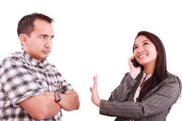 Image showing smiling businesswoman on the phone signaling his couple to hold 