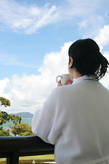 Image showing Professional businesswoman with a bath dress holding coffee cup 