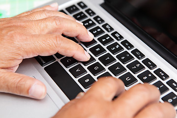 Image showing Hands of old man on computer