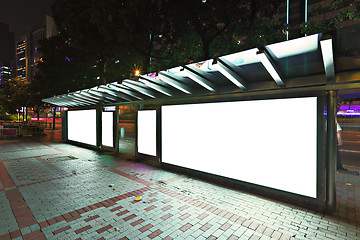 Image showing Blank billboard on bus stop at night 