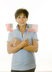 Image showing female middle age senior patriotic American with flags