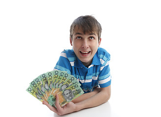 Image showing Boy with a fan of money banknotes