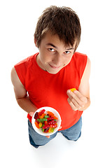 Image showing Boy eating lollies