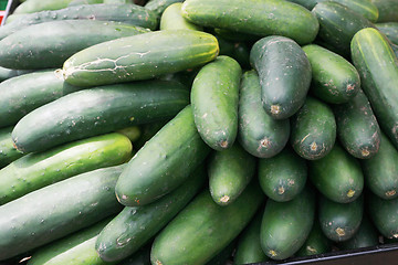 Image showing cucumbers bunched together for sale at market good as a backgrou