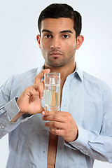 Image showing Man holding glass bottle men's cologne