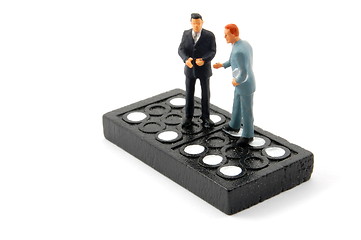 Image showing business man on domino isolated