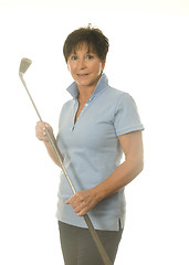 Image showing female middle age senior woman athlete with gold iron club