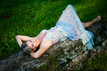 Image showing attractive woman lying on stones