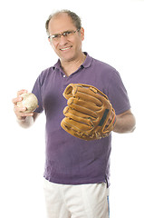 Image showing   middle age senior man softball throwing into baseball glove on