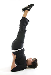 Image showing middle age woman demonstrating yoga position half shoulderstand 
