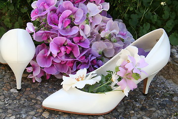 Image showing White pumps and flowers