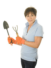 Image showing middle age senior woman gardener with spade and cultivator tools