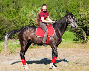 Image showing The girl on the black stallion