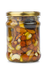 Image showing Glass jar with honey, nuts and figs