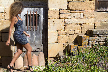 Image showing Sexy woman walking in a village