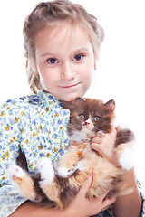 Image showing girl gently embracing tortoise British kitten